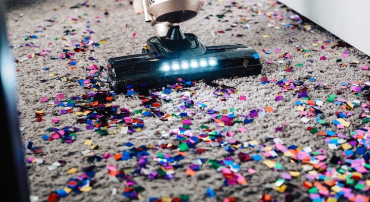 a person using a vacuum to clean a carpet