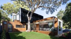 brown wooden house near green trees during daytime