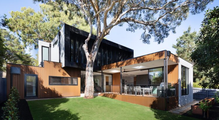 brown wooden house near green trees during daytime