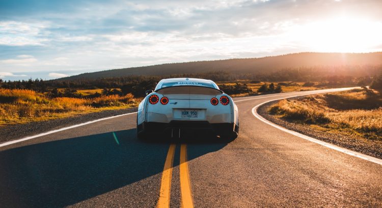 silver sports coupe on asphalt road